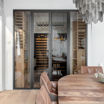 Platzsparende Weinlagerlösung integriert in eine moderne skandinavische Glasvitrine.